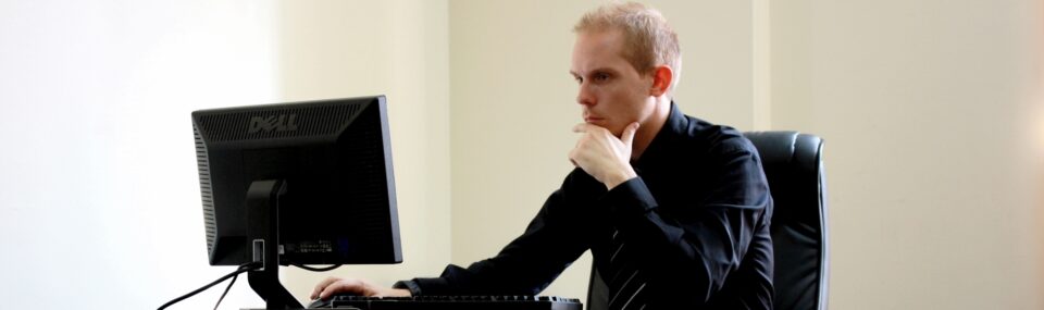 man in black shirt at Dell monitor
